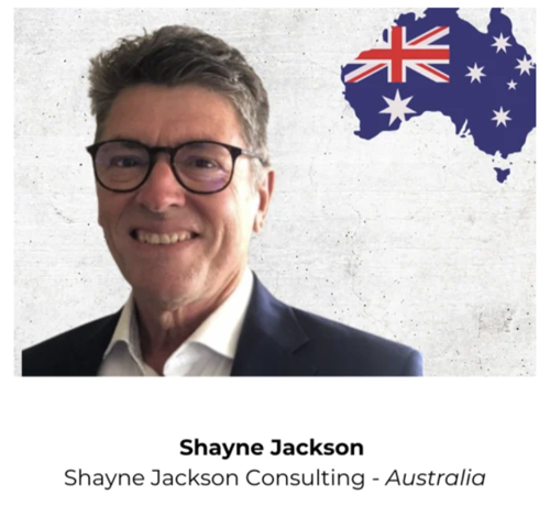 Shayne Jackson Portrait A professional headshot of Shayne Jackson, a consultant from Australia, with the Australian flag in the background.